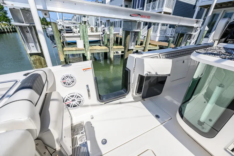 Slide: The Image of 2019 Wellcraft 352 Fisherman boat interior with open door, docked at marina. - 6