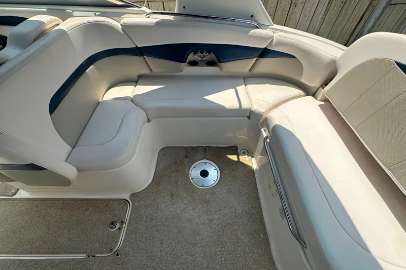 Slide: The Image of 2011 Chaparral 287 SSX boat interior with beige and blue seating arrangement. - 15