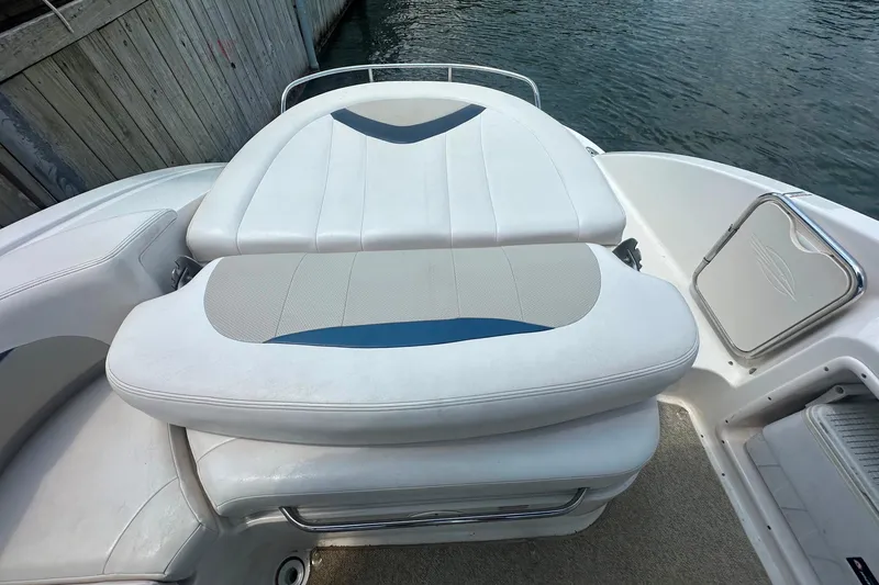 Slide: The Image of 2011 Chaparral 287 SSX boat interior with white cushioned seating near water. - 16