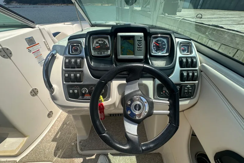Slide: The Image of Steering console of 2011 Chaparral 287 SSX boat with navigation and control panels. - 21
