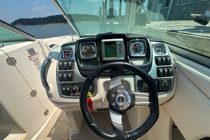 Slide: The Image of 2011 Chaparral 287 SSX boat dashboard with steering wheel and control panel. - 23
