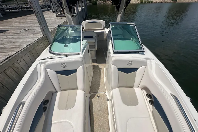 Slide: The Image of 2011 Chaparral 287 SSX boat interior with white seating and open windshield. - 28