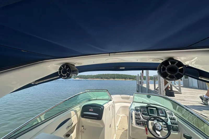 Slide: The Image of 2011 Chaparral 287 SSX boat interior with dashboard, speakers, and lake view. - 35