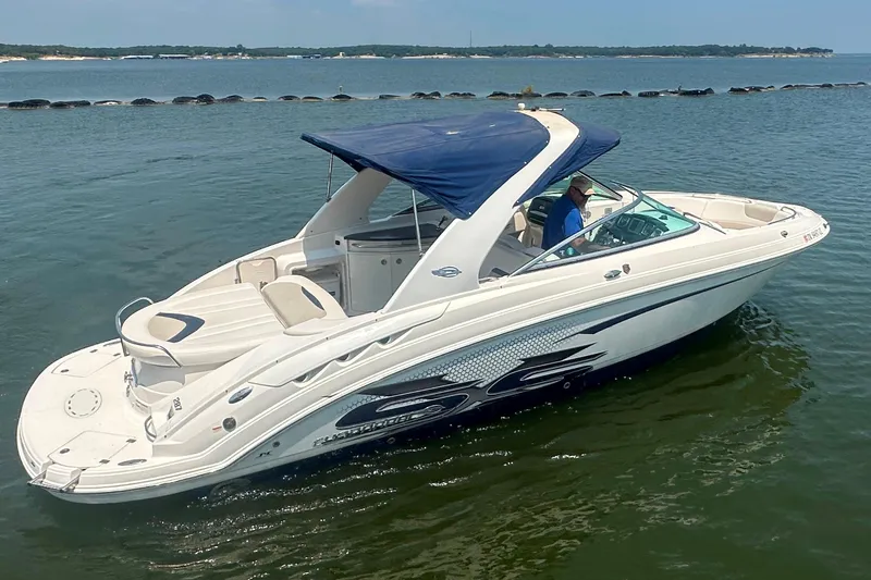 Slide: The Image of 2011 Chaparral 287 SSX boat with blue canopy on calm water. - 7