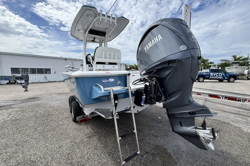 Slide: The Image of 2026 Tidewater 2410 Bay Max boat with Yamaha outboard motor, parked outdoors. - 10