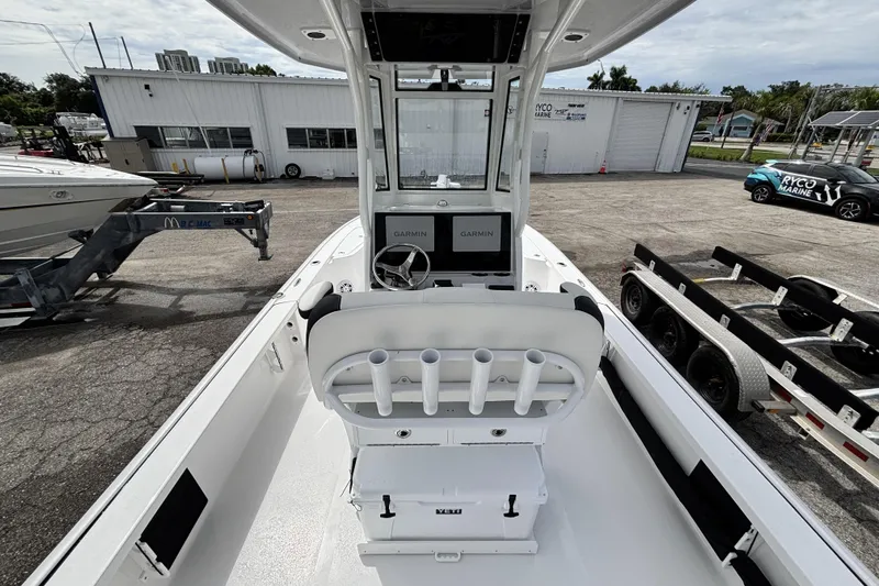 Slide: The Image of 2026 Tidewater 2410 Bay Max boat interior with Garmin navigation, docked at a marina. - 15