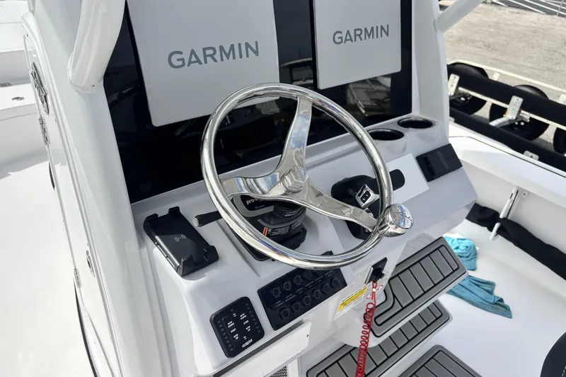 Slide: The Image of 2026 Tidewater 2410 Bay Max boat dashboard with Garmin displays and steering wheel. - 20