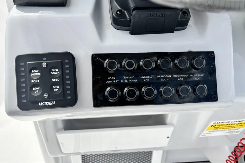 Slide: The Image of Control panel of 2026 Tidewater 2410 Bay Max boat with various switches and buttons. - 21