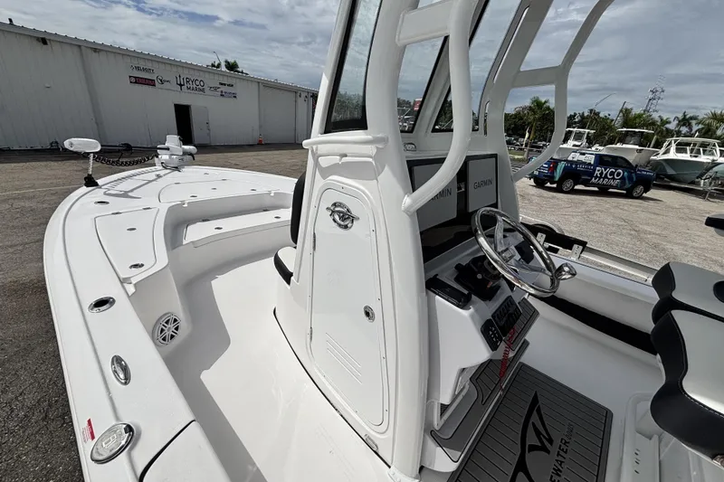 Slide: The Image of 2026 Tidewater 2410 Bay Max boat interior with steering console and seating. - 24