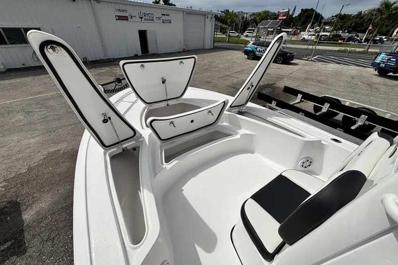 Slide: The Image of 2026 Tidewater 2410 Bay Max boat with open storage compartments and seating. - 31
