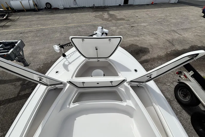 Slide: The Image of 2026 Tidewater 2410 Bay Max boat with open storage compartments on deck. - 32