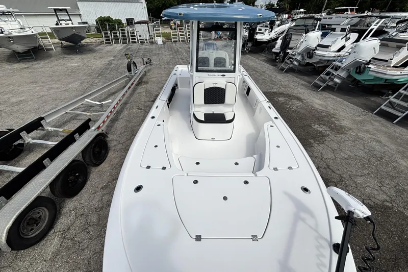 Slide: The Image of 2026 Tidewater 2410 Bay Max boat in a marina, showcasing spacious deck and seating. - 33