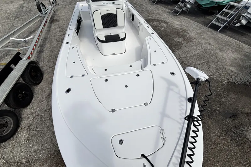 Slide: The Image of 2026 Tidewater 2410 Bay Max boat, white deck, parked on a trailer. - 34