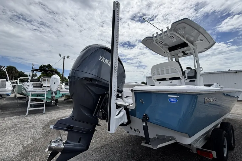 Slide: The Image of 2026 Tidewater 2410 Bay Max boat with Yamaha outboard motor, parked outdoors. - 6