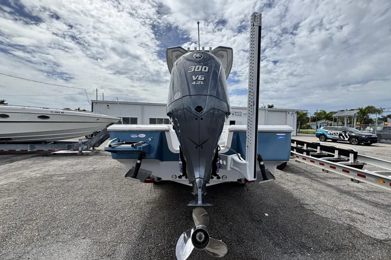 Slide: The Image of 2026 Tidewater 2410 Bay Max boat with powerful 300 V6 engine, parked outdoors. - 7