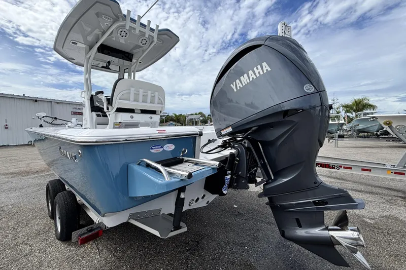 Slide: The Image of 2026 Tidewater 2410 Bay Max boat with Yamaha engine on trailer, under cloudy sky. - 9