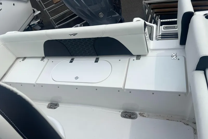 Slide: The Image of 2025 Tidewater 232 LXF boat interior with seating and storage compartments. - 12