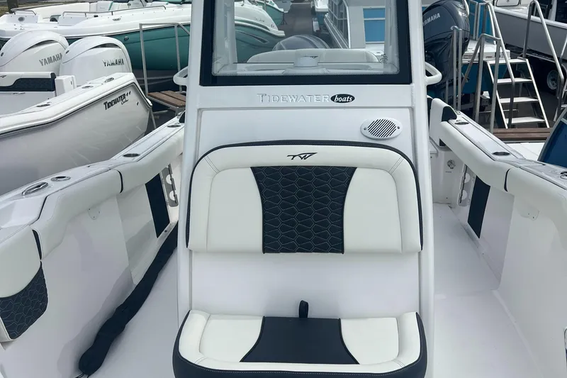 Slide: The Image of 2025 Tidewater 232 LXF boat interior with cushioned seating and sleek design. - 6