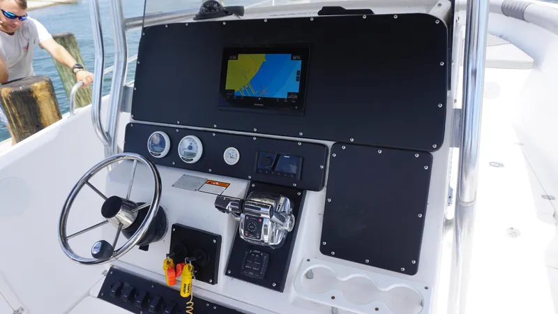 Slide: The Image of Century 3100 boat dashboard with navigation screen and controls, 2000 model. - 11