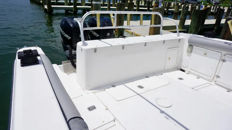 Slide: The Image of Century 3100 boat, 2000 model, with Mercury outboard engines docked at a marina. - 13