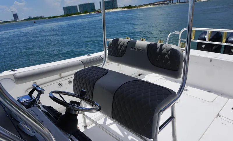 Slide: The Image of Century 3100 boat interior with cushioned seating, steering wheel, and ocean view, year 2000 model. - 14