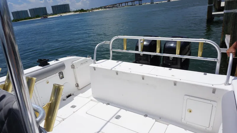 Slide: The Image of Century 3100 boat, 2000 model, docked with dual outboard motors, overlooking a scenic waterfront. - 15