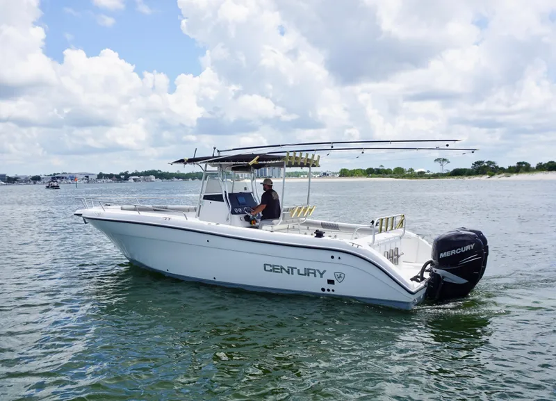 Slide: The Image of Century 3100 boat from 2000 on water, featuring Mercury outboard motor, under a cloudy sky. - 3
