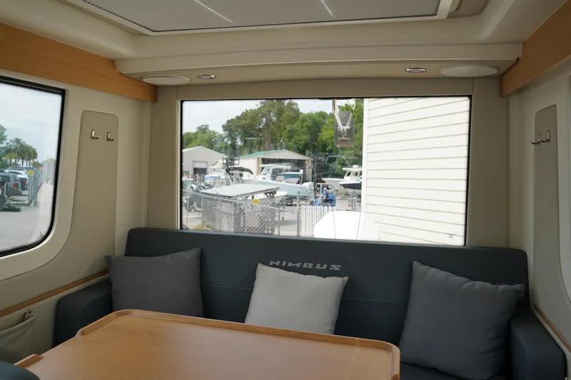 Slide: The Image of Interior of 2024 Nimbus Commuter9 C9 boat with cozy seating and large window view. - 15