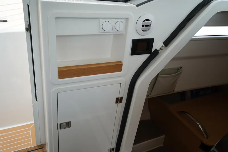 Slide: The Image of 2024 Nimbus Commuter9 C9 interior detail with storage and control panel. - 29