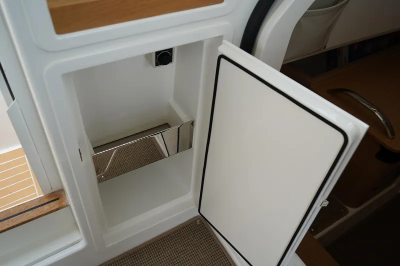 Slide: The Image of Open storage compartment in 2024 Nimbus Commuter9 C9 boat interior. - 30