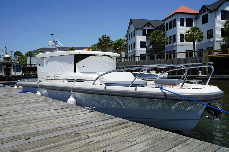 Slide: The Image of 2024 Nimbus Commuter9 C9 boat docked near waterfront buildings. - 7