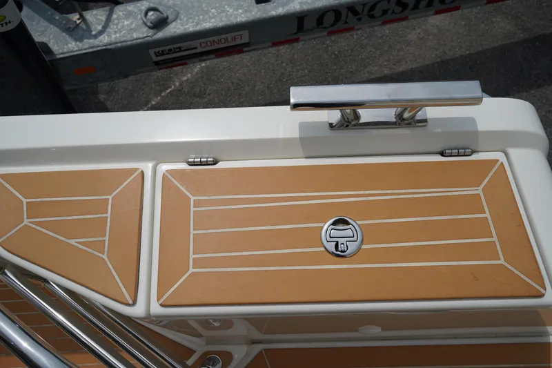 Slide: The Image of 2024 Nimbus Commuter9 C9 boat deck with teak finish and chrome handle. - 13