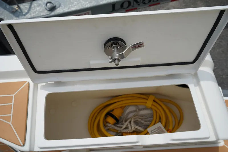 Slide: The Image of Open storage compartment on 2024 Nimbus Commuter9 C9 with yellow cable inside. - 14