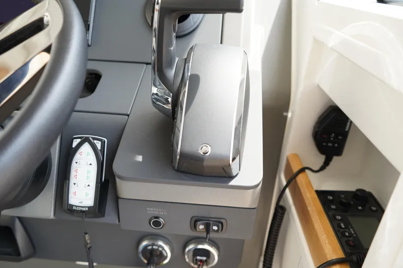 Slide: The Image of 2024 Nimbus Commuter9 C9 boat control panel with steering wheel and throttle lever. - 36