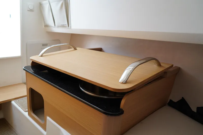 Slide: The Image of 2024 Nimbus Commuter9 C9 interior with wooden storage compartment and metal handles. - 45