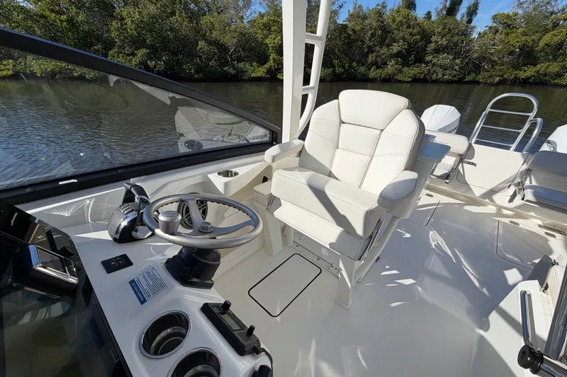 Slide: The Image of 2026 World Cat 265 DC-X boat interior with steering wheel and captain's chair. - 10