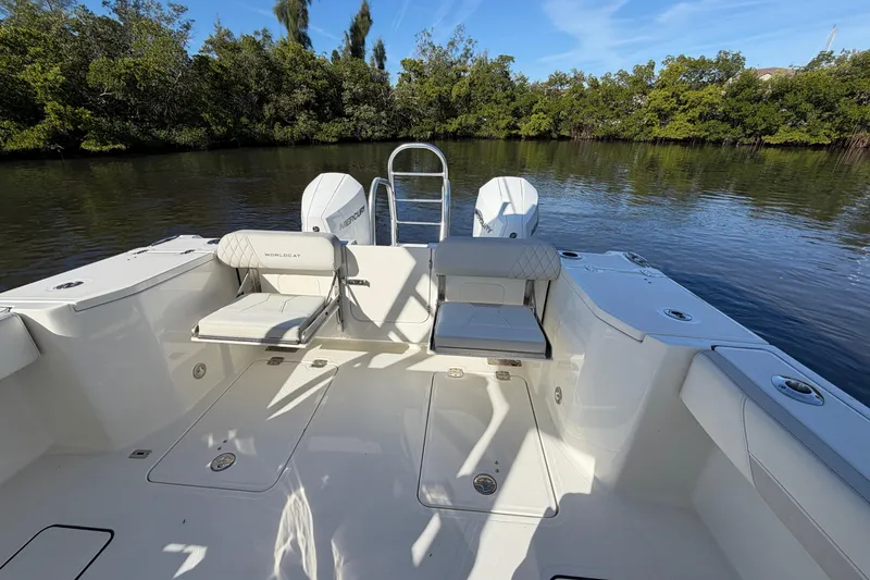 Slide: The Image of 2026 World Cat 265 DC-X boat interior with seating, on a calm river. - 11