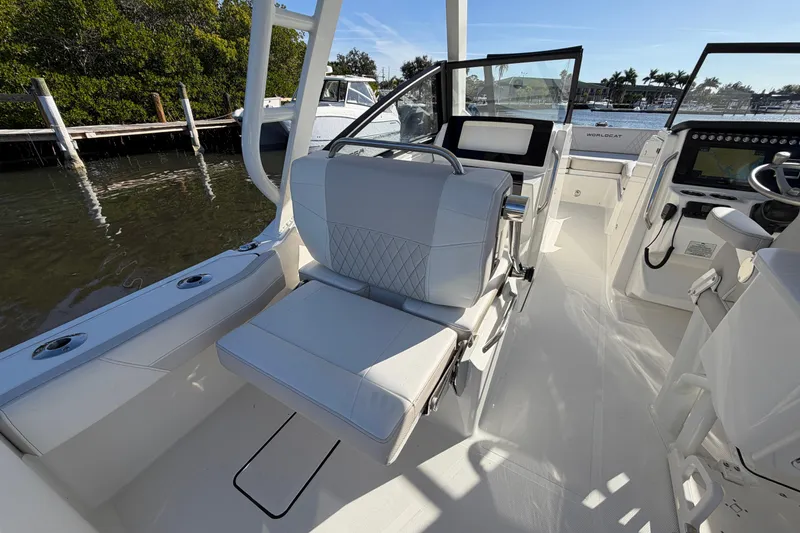 Slide: The Image of 2026 World Cat 265 DC-X boat interior with luxurious seating and modern dashboard. - 13