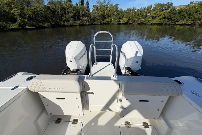 Slide: The Image of 2026 World Cat 265 DC-X boat with dual Mercury engines on a calm river. - 15