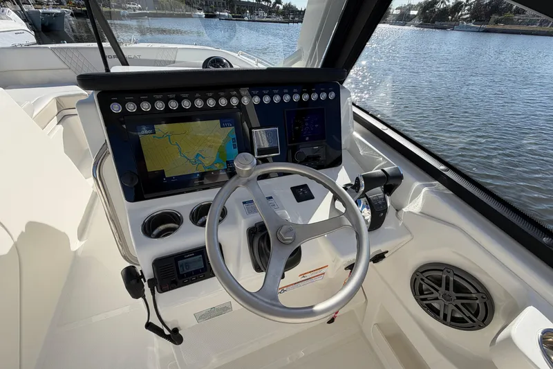 Slide: The Image of Helm of 2026 World Cat 265 DC-X with navigation display, steering wheel, and controls. - 17