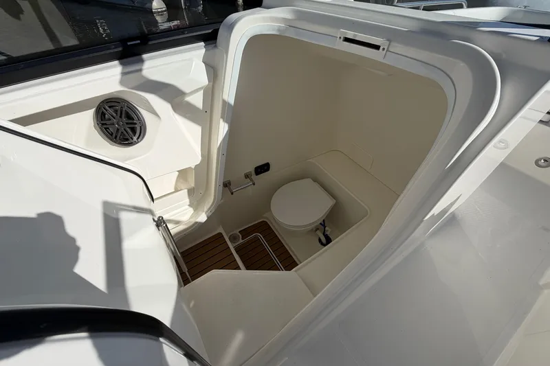 Slide: The Image of 2026 World Cat 265 DC-X boat interior with compact marine toilet and speaker. - 19