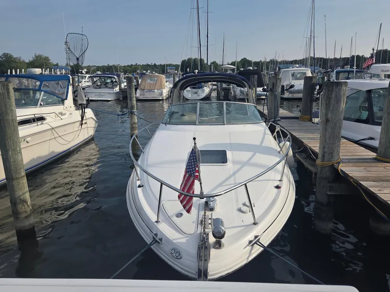 Slide: The Image of 2004 Sea Ray 280 Sundancer docked at marina with American flag. - 6