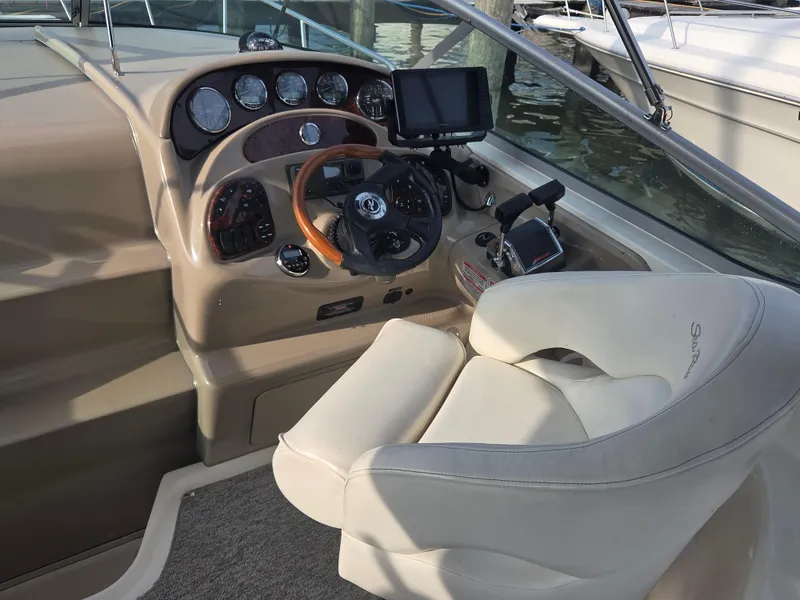 Slide: The Image of 2004 Sea Ray 280 Sundancer helm with steering wheel, gauges, and navigation equipment. - 8
