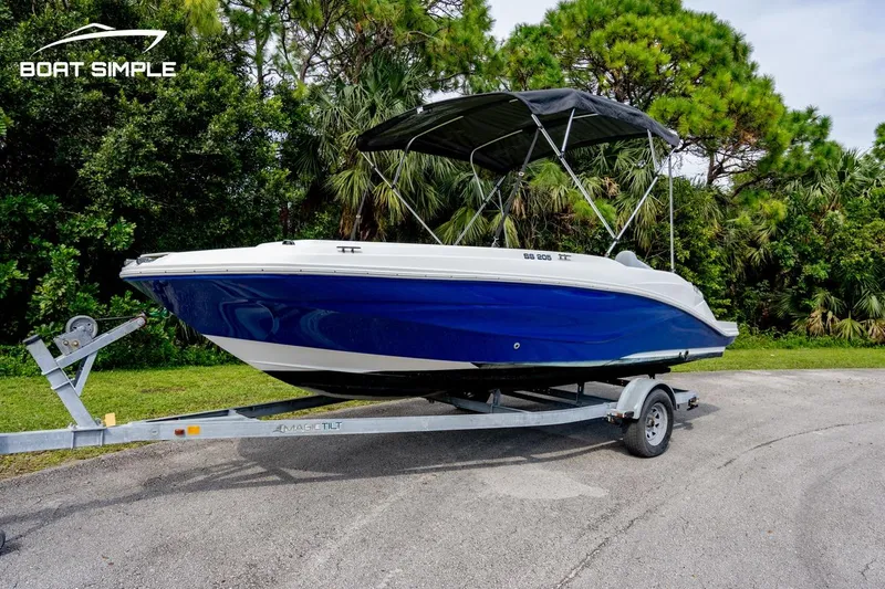 Slide: The Image of 2021 Hurricane SunDeck Sport 205 OB boat on trailer, parked outdoors. - 0