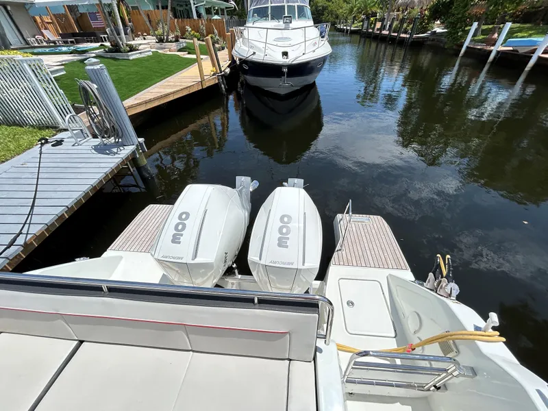 Slide: The Image of 2022 Jeanneau Leader 10.5 WA Series 2 with twin Mercury 300 engines docked in a canal. - 16