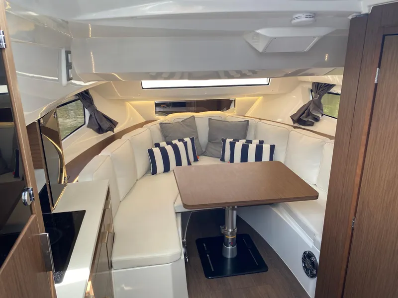 Slide: The Image of Interior of 2022 Jeanneau Leader 10.5 WA Series 2 with cozy seating and table. - 18