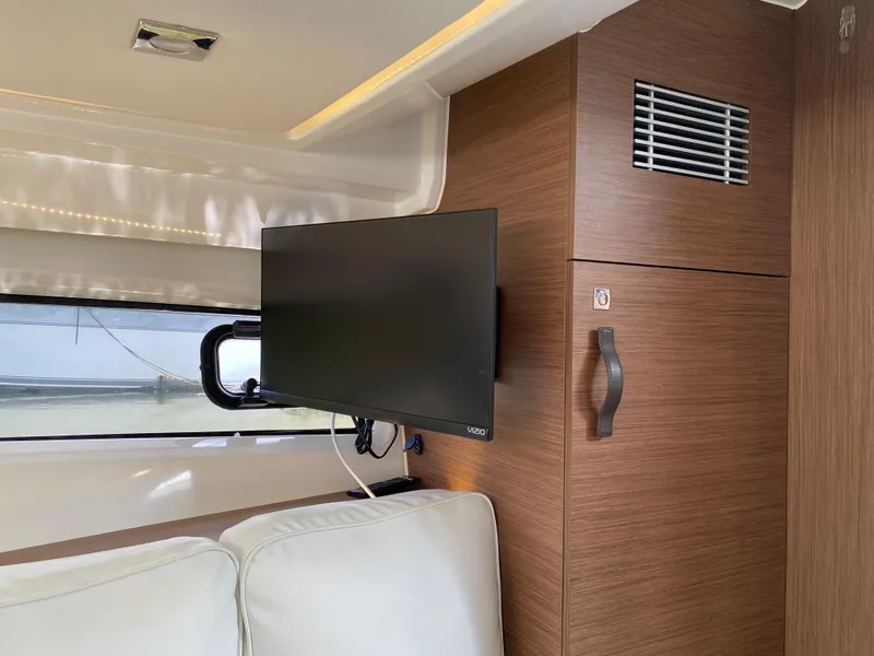 Slide: The Image of Interior of 2022 Jeanneau Leader 10.5 WA Series 2 with TV and wooden cabinetry. - 22