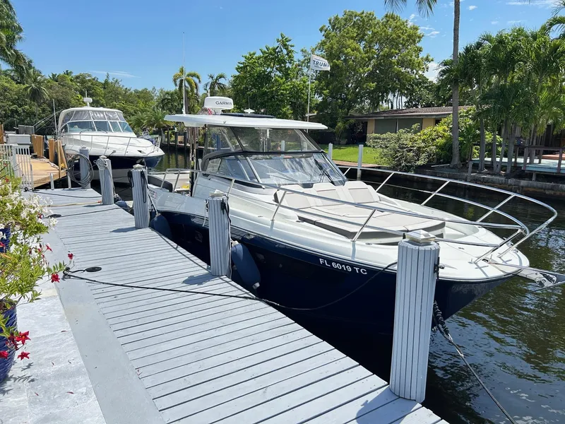 Slide: The Image of 2022 Jeanneau Leader 10.5 WA Series 2 docked by a scenic waterfront. - 4