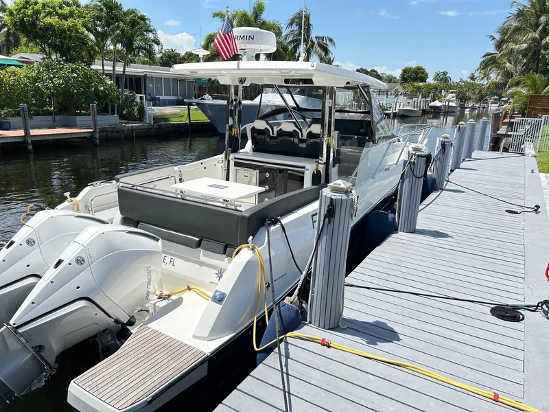 Slide: The Image of 2022 Jeanneau Leader 10.5 WA Series 2 docked, featuring dual outboard engines. - 5