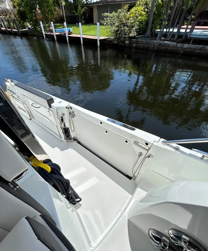 Slide: The Image of 2022 Jeanneau Leader 10.5 WA Series 2 boat docked by a calm canal. - 8